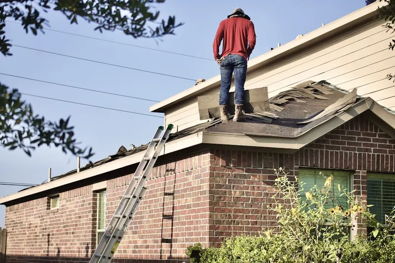 Professional roofer working on a residential roof in Butler West